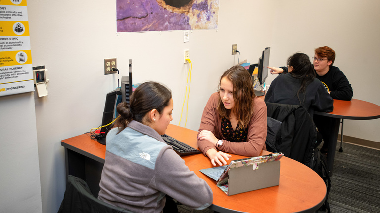 engineering students tutoring at desk
